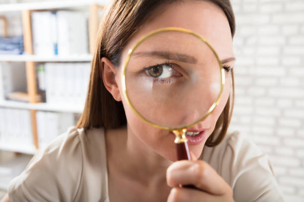 istock Businesswoman Looking Through Magnifying Glass 928087950