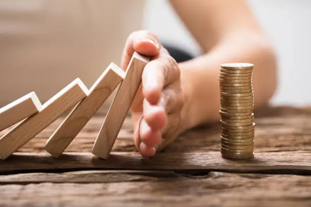 Photo of Close-up Of A Businesswoman's Hand Stopping Falling Blocks