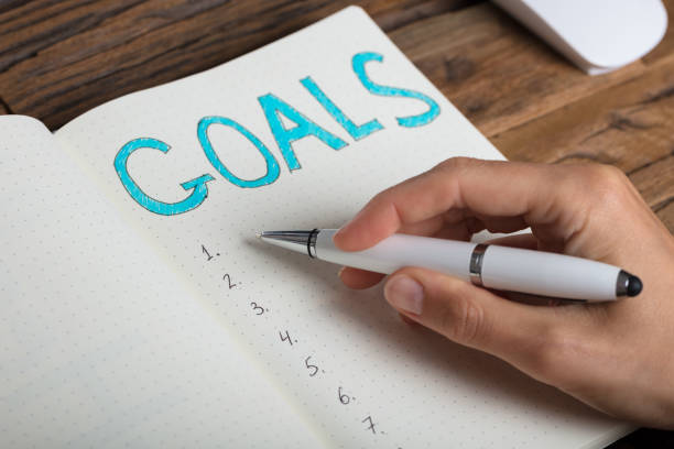 istock Businessperson's Hand Writing Goal Concept 928088300