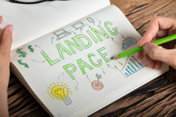 Human Hand Drawing Landing Page Concept On Notebook Close-up Of A Human Hand Drawing Landing Page Concept On Notebook At Desk landing page photos stock pictures, royalty-free photos & images
