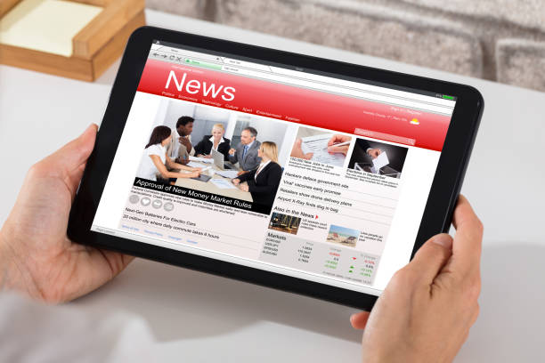 istock Person Holding Digital Tablet With News On Screen 928088404