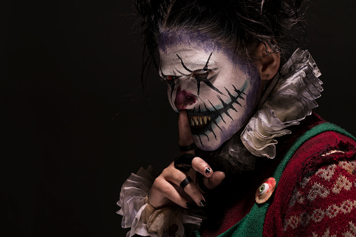 Creepy Female Clown with fingers on lips
