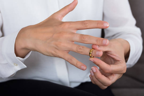 istock Woman Putting On A Shiny Gold Ring 928088978