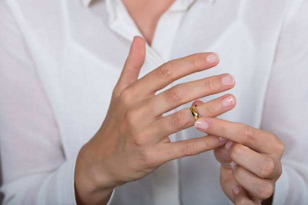 istock Woman Putting On A Shiny Gold Ring 928088982