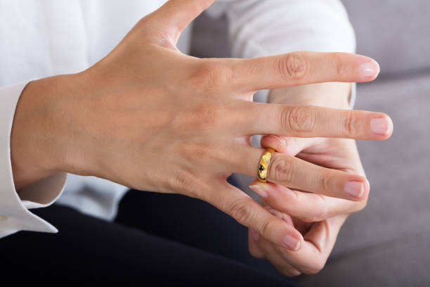 istock Woman Putting On A Shiny Gold Ring 928088994