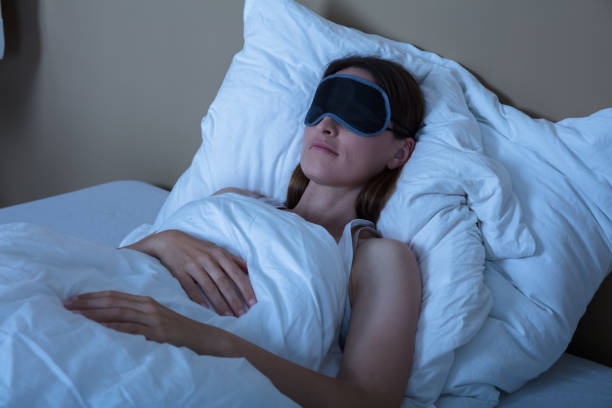 istock Woman Sleeping In Bed With Eye Mask 928089276