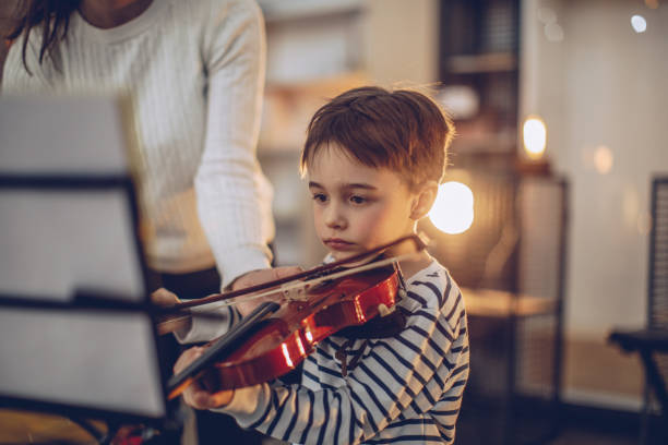 istock Cute boy teaching to play violin 928089396