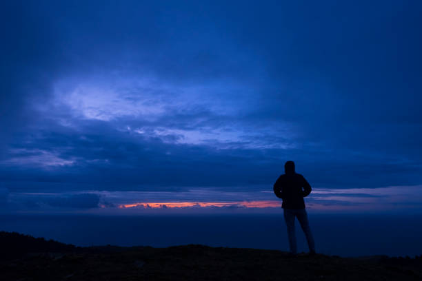 istock Man looking at the sea at dusk on Mount 928091840