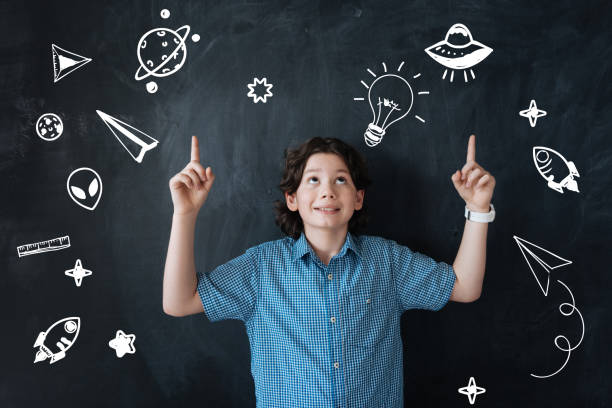 istock Emotional boy pointing to the sky while dreaming about exploring the space 928095064