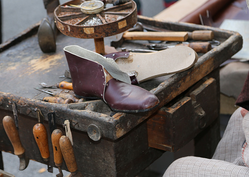old shop of a shoemaker craftsman with a leather shoe