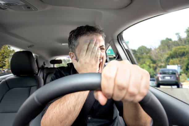 istock Young man sitting in the care in frustration 928096362