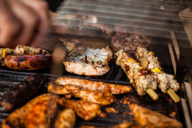 istock Gas barbecue with a variety on meat on it 928096406