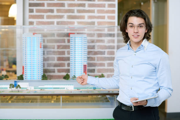 istock Cheerful confident real estate agent presenting new house project 928096884