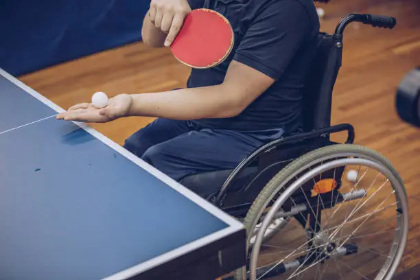 Young boy in a wheelchair playing table tennis