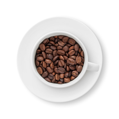 Top view of a coffee cup and saucer with coffee beans isolated on white (excluding the shadow)