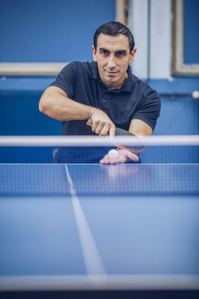 istock Man in a wheelchair playing table tennis 928103644