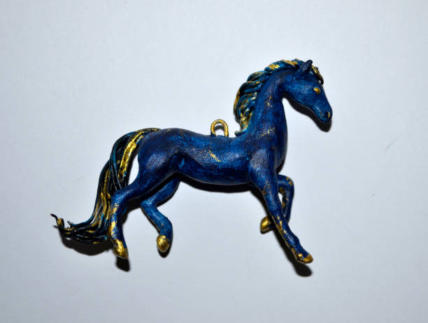 istock Small pendant in the form of blue and gold hourse 928107342