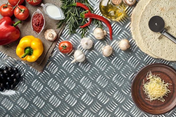istock Cheese, different vegetables on metal table. Ingredients for traditional italian pizza 928111982