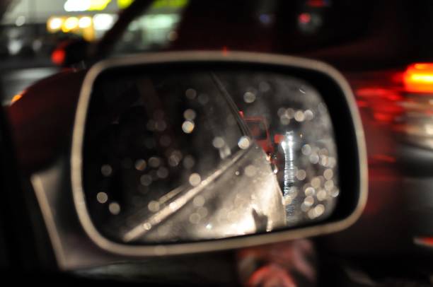 blurry view by car side mirror at night. - snow driving side view mirror rain imagens e fotografias de stock