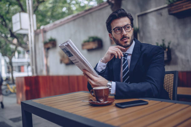istock Man reading newspaper in coffee shop 928119616