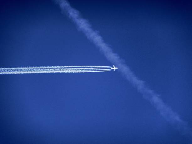 istock Low Angle View Of Airplane Flying Against Clear Blue Sky 928120294