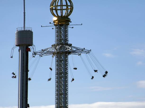 istock Low Angle View Of Chain Swing Ride Against Blue Sky 928121438