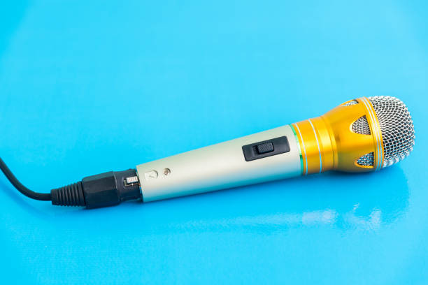 istock Close-Up Of Microphone On Blue Table 928127070