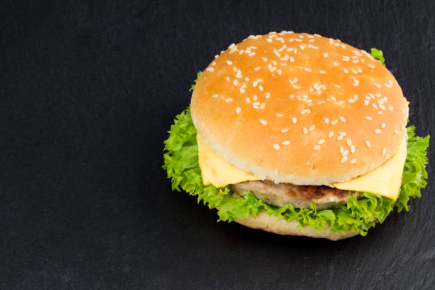 istock fresh tasty burger on black textured background 928130266