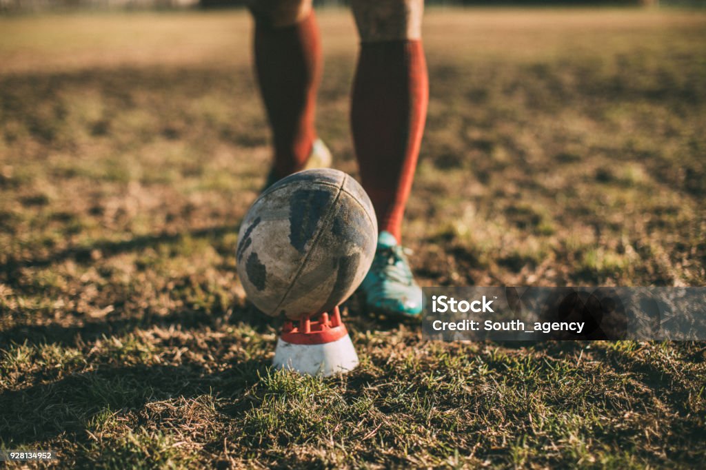 Free kick in rugby One man, rugby player on the field, kicking the rugby ball, part of. Rugby - Sport Stock Photo