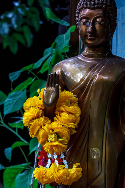 istock Marigold garland in right hand of Buddha statue 928137946