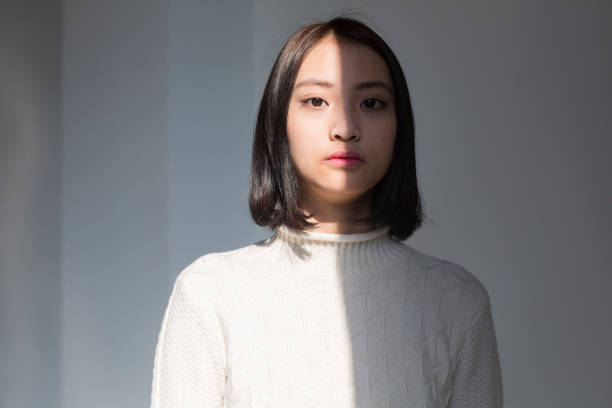 shadow of young woman,portrait - serious women asian ethnicity human face imagens e fotografias de stock
