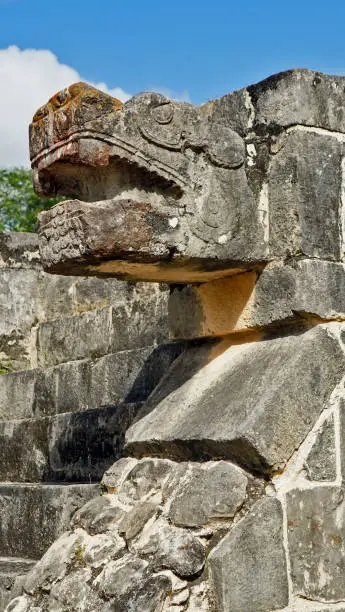 Stone snake head at the mayan pyramid in Yucatan Mexico
