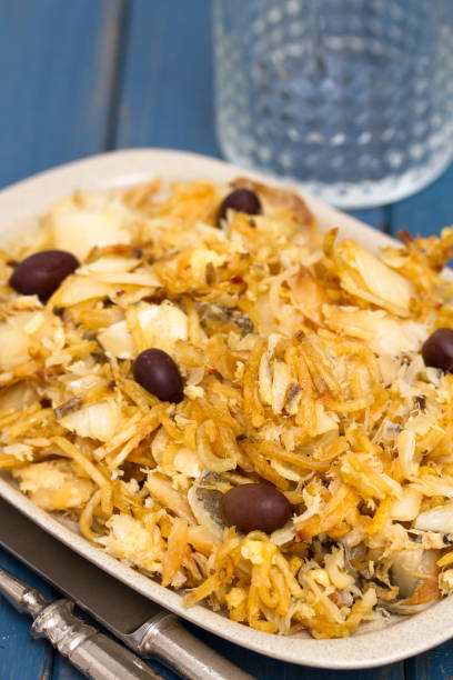 istock codfish with potato chips and olives on plate on blue background 928159396