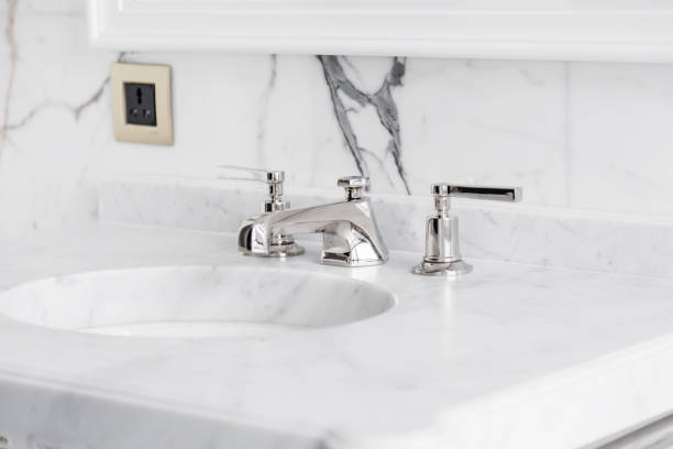 istock closeup faucet and lavatory white marble restroom interior concept 928161730