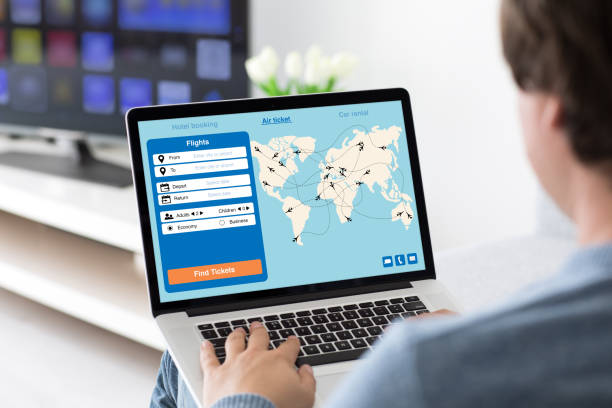 istock man holding laptop with application search air ticket screen room 928169736