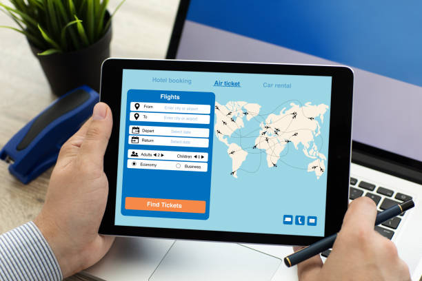 istock man holding tablet with application search air ticket on screen 928169772