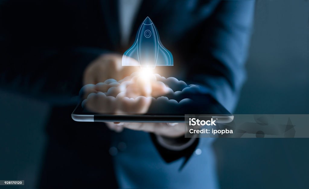 Startup concept, transparent rocket is launching and flying out of tablet on screen Taking Off - Activity Stock Photo