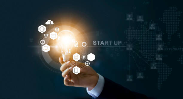 istock Startup concept. Businessman holding light bulb with start up and icon network connection on modern virtual interface 928170130