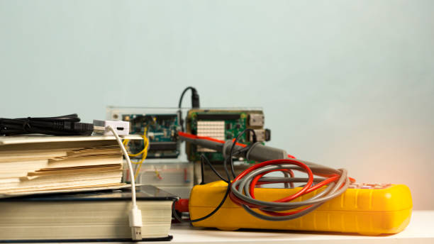 istock Textbooks on white wooden table, with blurry electronics experimental circuit board and oscilloscope. Use as educational concept , including copy space. 928170588