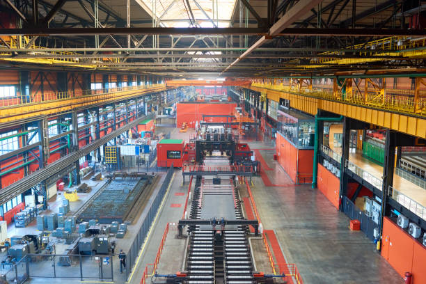 High angle view of conveyor belt line with moving metal sheets at metallurgical plant