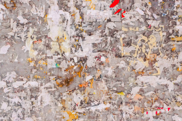 istock Old wall with remains of paper ads as background 928176990