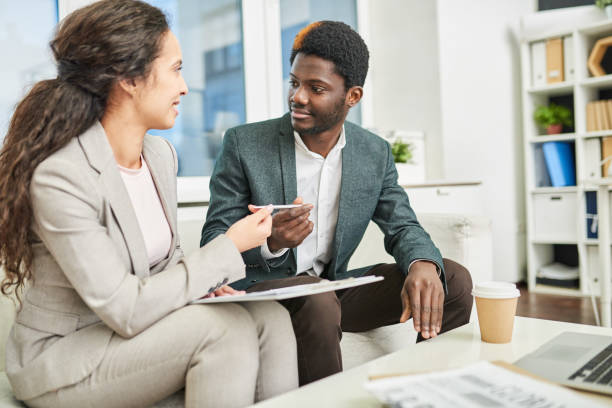istock Lawyer reading contract together with client 928180254
