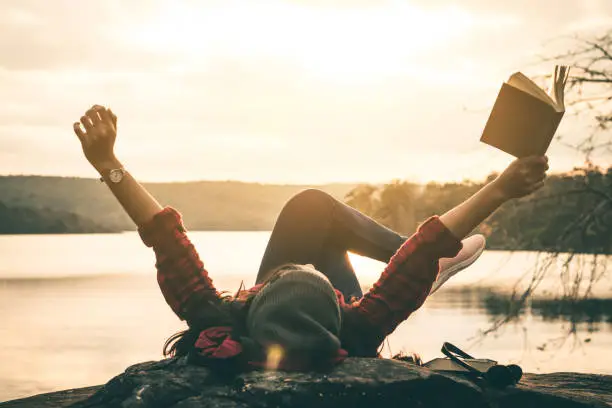 Photo of Women tourists read books in quiet nature.