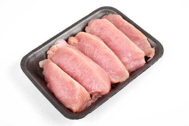 istock Raw turkey meat in tray, isolated on white background 928184284