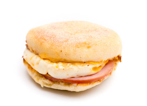Egg, Canadian Bacon and Cheese Breakfast Sandwich on a White Background Egg, Canadian Bacon and Cheese Breakfast Sandwich on a White Background biscuit quick bread stock pictures, royalty-free photos & images