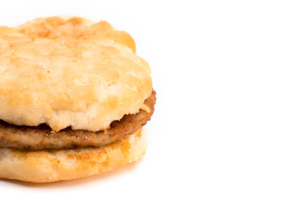 Sausage Biscuit Breakfast Sandwich on a White Background Sausage Biscuit Breakfast Sandwich on a White Background biscuit quick bread photos stock pictures, royalty-free photos & images