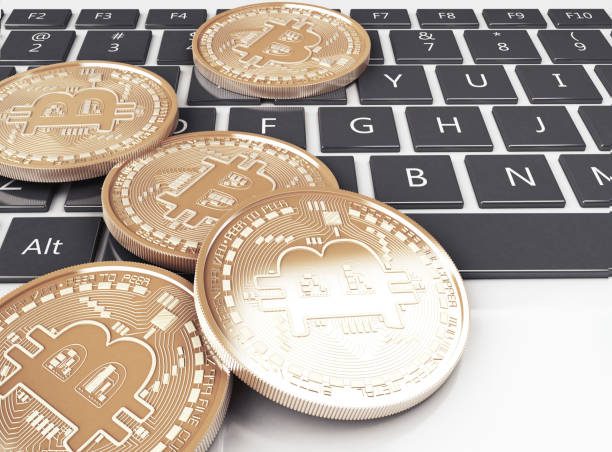 istock 3d Pile of bitcoin gold coins on a computer keyboard 928185326