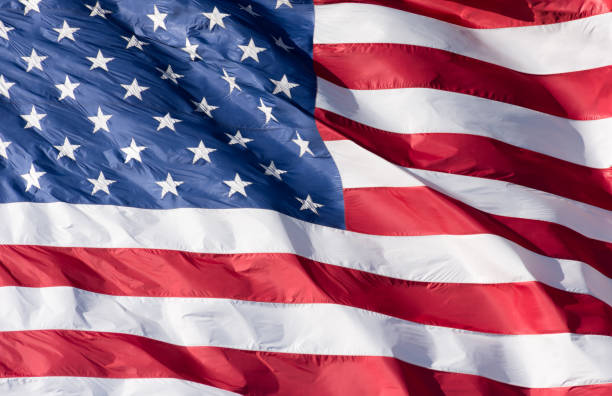 American Flag Close Up Close up of a red, white and blue American flag with stars and strips unfurled in the wind. 8571 stock pictures, royalty-free photos & images