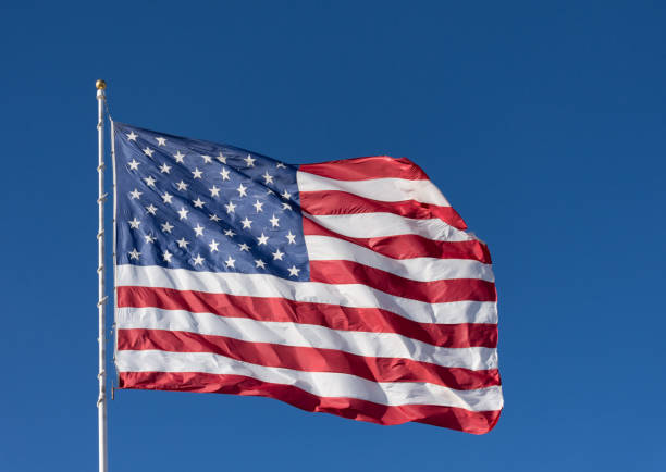 istock An American Flag against a Brilliant Blue Sky 928188344