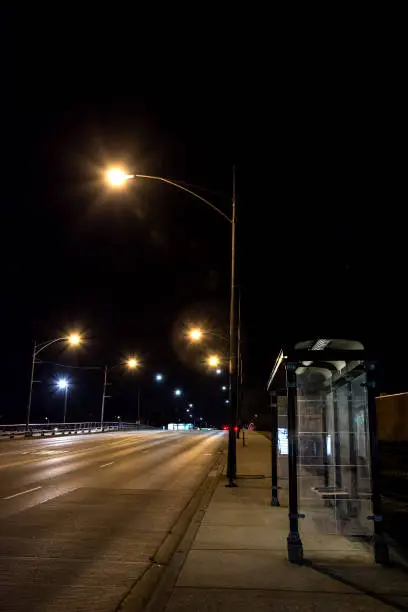 Photo of City bridge road with bus stop at night